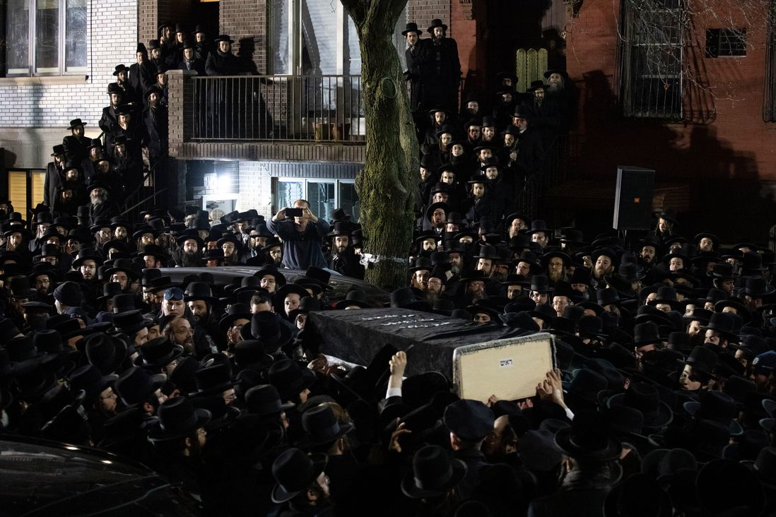 Orthodox Jewish men carry Moshe Deutsch's casket outside a Brooklyn synagogue following his funeral, in New York. Deutsch was killed Tuesday in a shooting inside a Jersey City, N.J. kosher food market